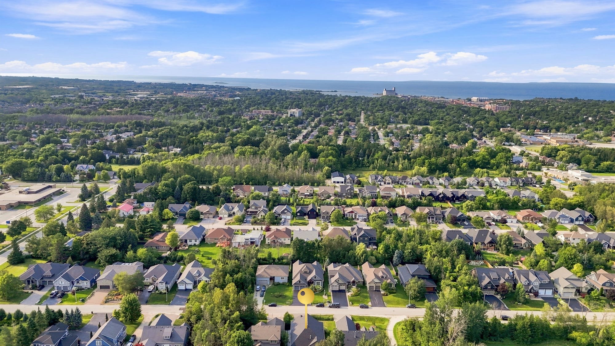 Aerial over the Collingwood neighbourhood surrounding 110 Mary Street, looking north to downtown and Georgian Bay